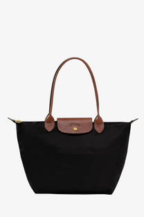 Black Longchamp women’s Le Pliage original nylon tote bag with brown leather handles and gold-tone hardware