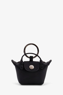 Longchamp women’s le pliage xtra leather keychain black featuring a black mini handbag with circular handle and silver logo clasp