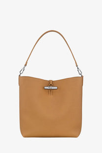 Longchamp women’s le roseau brown leather bucket bag with tan leather, silver-tone clasp, and matching shoulder strap