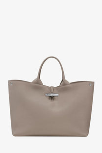 Beige longchamp women’s le roseau leather tote bag with textured finish and silver-tone metal clasp and handles