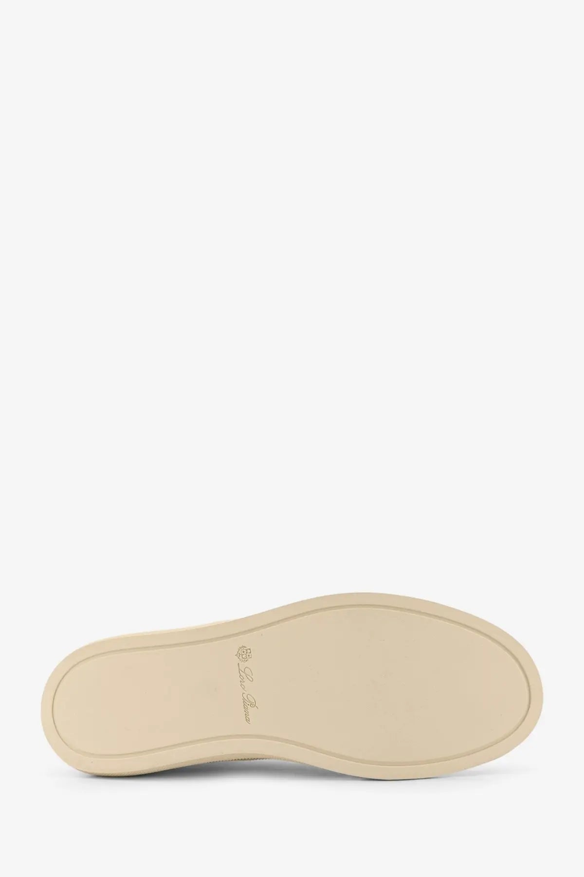 Beige rubber sole with subtle embossed logo on loro piana women’s white canvas sneakers back side