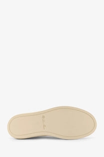 Beige rubber sole with subtle embossed logo on loro piana women’s white canvas sneakers back side