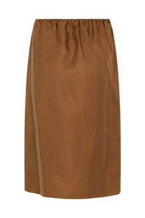 A sleek caramel-colored satin midi skirt with gathered waistband from Loulou De Saison Vasali Brown collection
