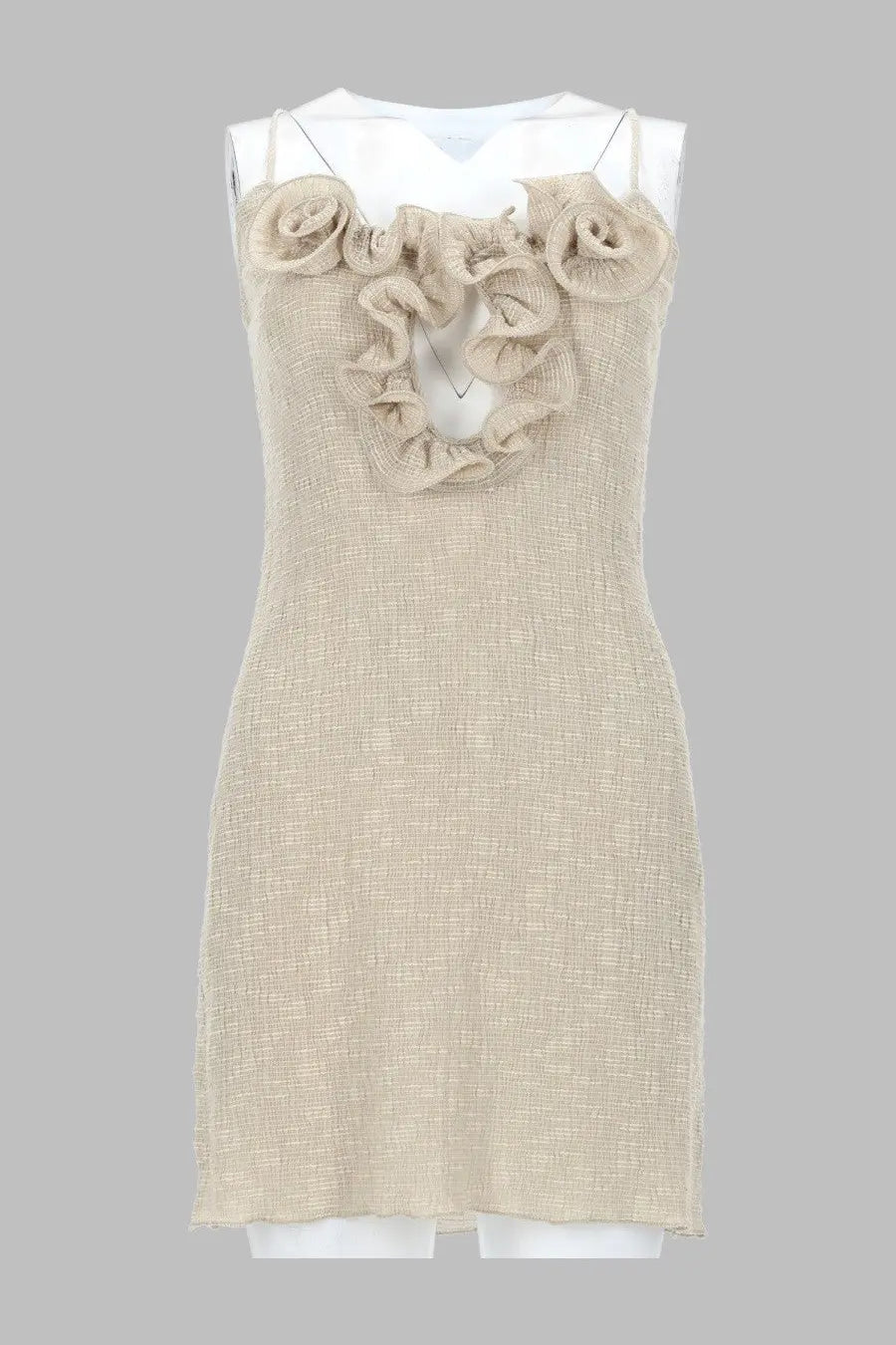 Beige textured fabric sleeveless dress adorned with ruffled rose embellishments at the neckline.