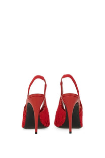 Red lace crochet slingback heels by magda butrym with a glossy finish and black soles, shown from the back side