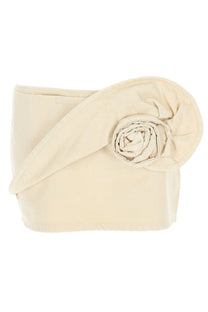 Cream-colored fabric clutch with rolled rose accent paired with Magda Butrym women’s beige denim miniskirt