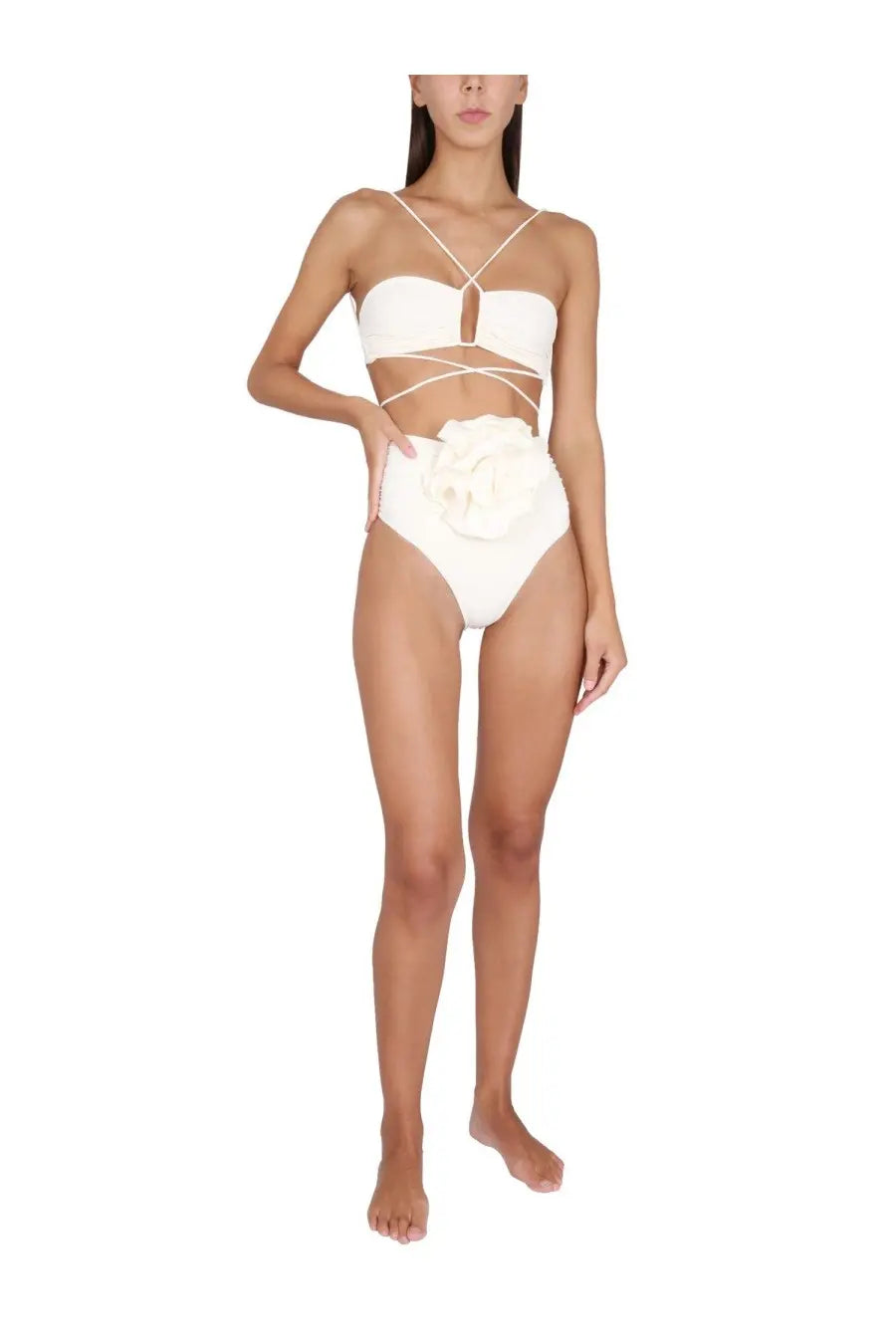 White magda butrym one-piece swimsuit with crisscross straps and large floral embellishment on the hip