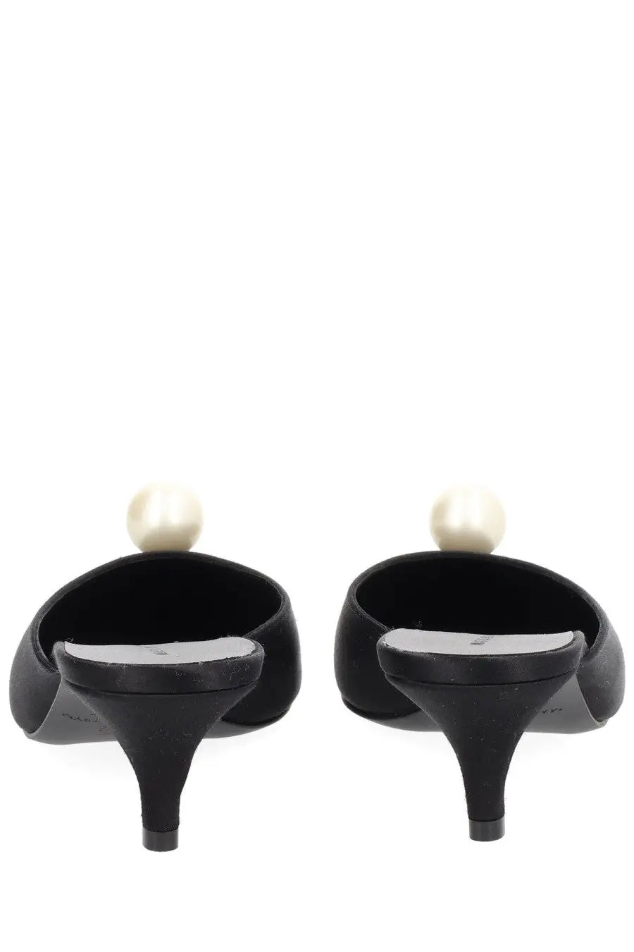 Back view of magda butrym women’s black satin mules with a single pearl detail on each heel