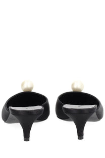 Back view of magda butrym women’s black satin mules with a single pearl detail on each heel