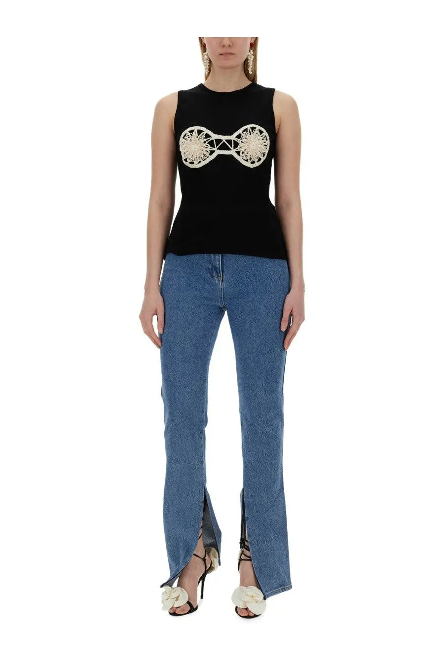 Black sleeveless top by magda butrym featuring cream embroidered circular design on the chest