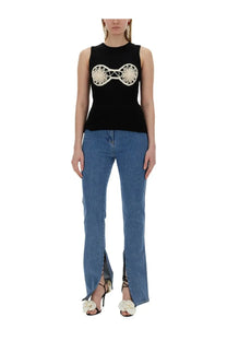 Black sleeveless top by magda butrym featuring cream embroidered circular design on the chest