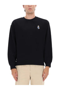 Maison Kitsuné men’s black crewneck sweatshirt with a small embroidered bear patch on the left chest