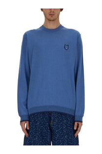 Maison Kitsuné men’s blue knit sweater with small embroidered wolf logo on left chest made from fox head jersey