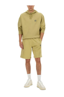 Oliver green kenzo tiger logo hoodie and matching shorts set paired with maison kitsuné men’s oversized beige hoodie