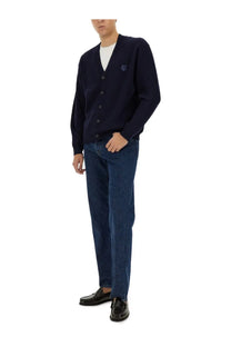 Navy blue ribbed knit cardigan with button closure and small embroidered logo on the left chest by Maison Kitsuné