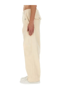 Cream-colored Maison Kitsuné men’s workwear cargo pants with multiple flap pockets and metallic button accents