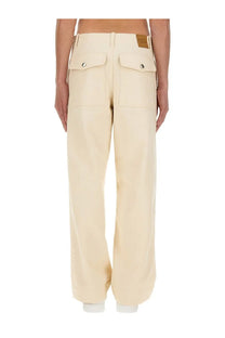 Maison Kitsuné men’s white wide-leg workwear pants with cream color front pockets and brown leather brand patch