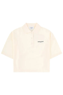Cream-colored short-sleeved Maison Kitsuné women’s polo shirt with subtle embroidered logo on the chest