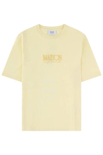 A pale yellow Maison Kitsuné women’s shirt with a subtle gold embroidered logo across the chest