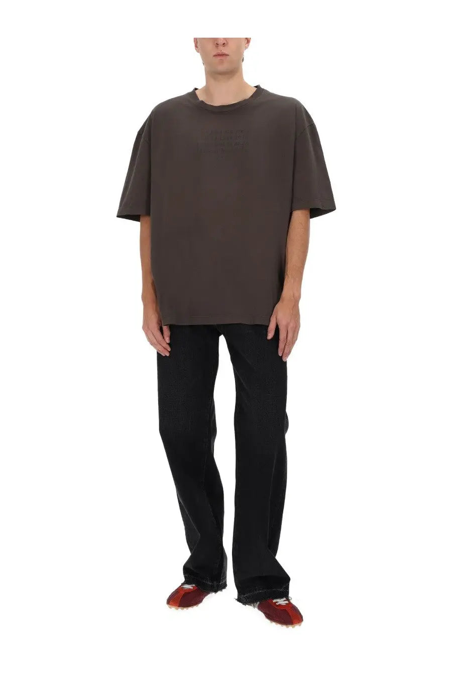 A loose-fitting dark gray short-sleeved t-shirt with a round neckline paired with maison margiela men’s black five pockets jeans