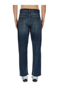 Maison Margiela men’s blue denim five pockets jeans with a straight-leg cut and frayed hems