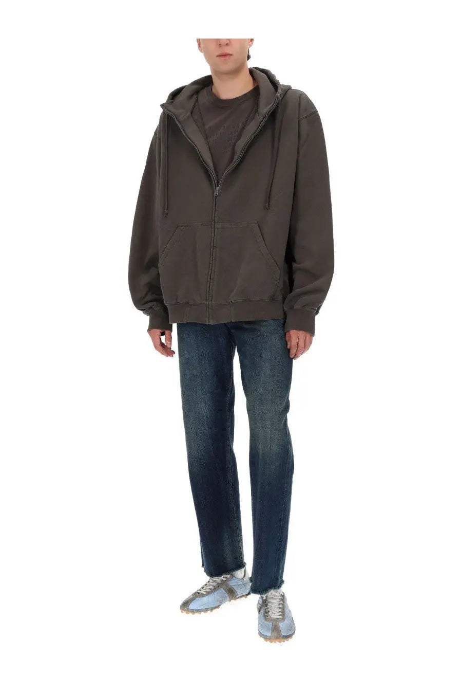 Olive green zip-up hoodie with drawstring hood and front pockets paired with maison margiela men’s five pockets blue jeans