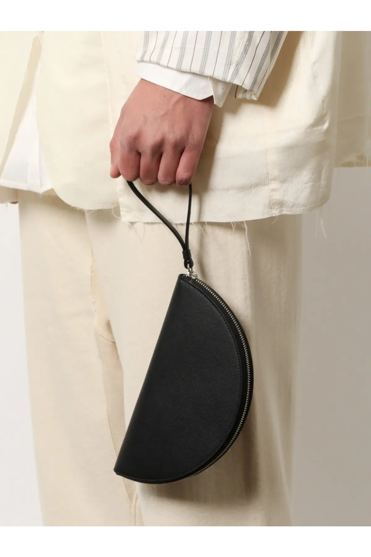 Maison Margiela men’s black leather pochette with half-moon shape, sleek zipper closure, and thin strap