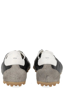 Maison margiela men’s sneaker sprinters in black with suede and leather, textured gray heel counter, and tan rubber sole