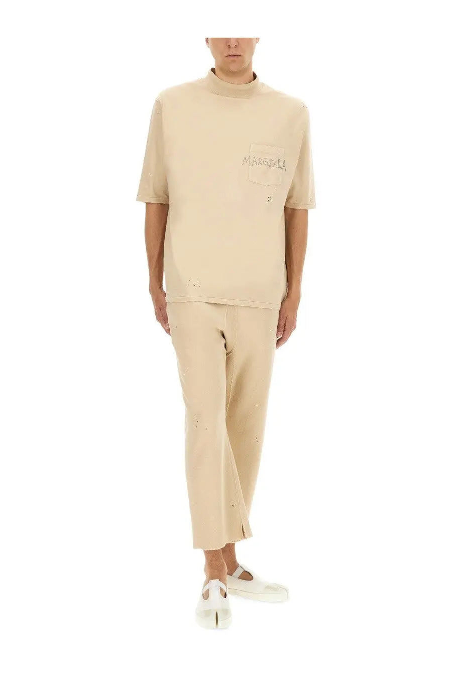 Beige high neck short-sleeved t-shirt with distressed details and marsèlla logo on chest pocket paired with white maison margiela cotton pants
