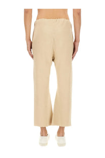 Maison Margiela unisex cotton pants in white featuring beige wide-leg trousers with relaxed fit and subtle front seam detailing