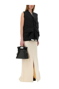 Black textured leather handbag with silver hardware and white label from maison margiela women anonymity lining skirt beige