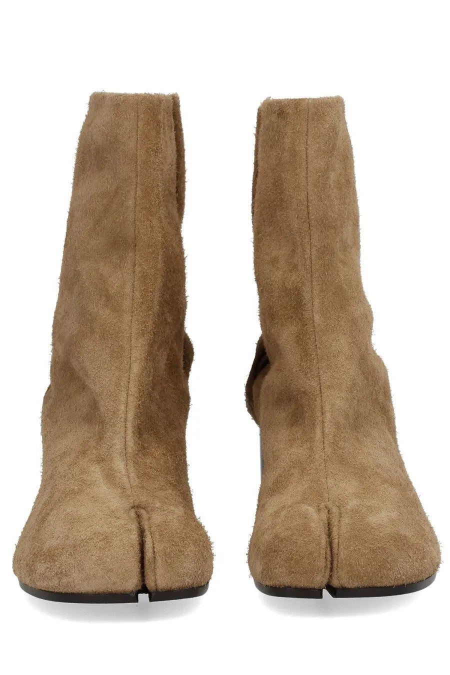 Maison Margiela women’s tan suede tabi boots with split-toe design and black soles shown from the back side
