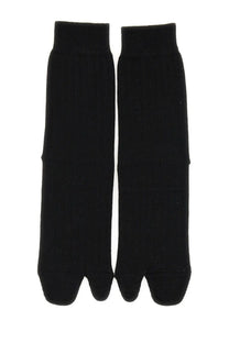 A pair of maison margiela women’s black ribbed knit toe separated socks made from soft fabric