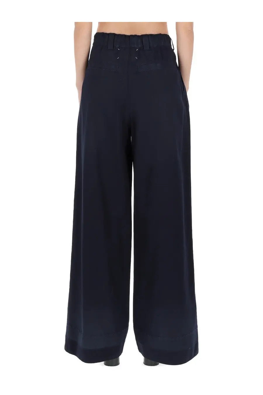 Dark navy maison margiela women’s chino pants with high waist and subtle back pleats shown from the back side