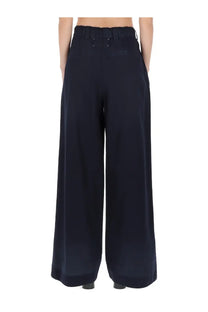 Dark navy maison margiela women’s chino pants with high waist and subtle back pleats shown from the back side