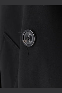A sleek circular silver button with polished finish on maison margiela women’s black cotton blend mini trench
