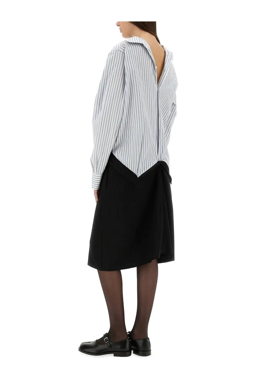 Back view of maison margiela women’s backless long-sleeved striped dress shirt in white and gray over black skirt