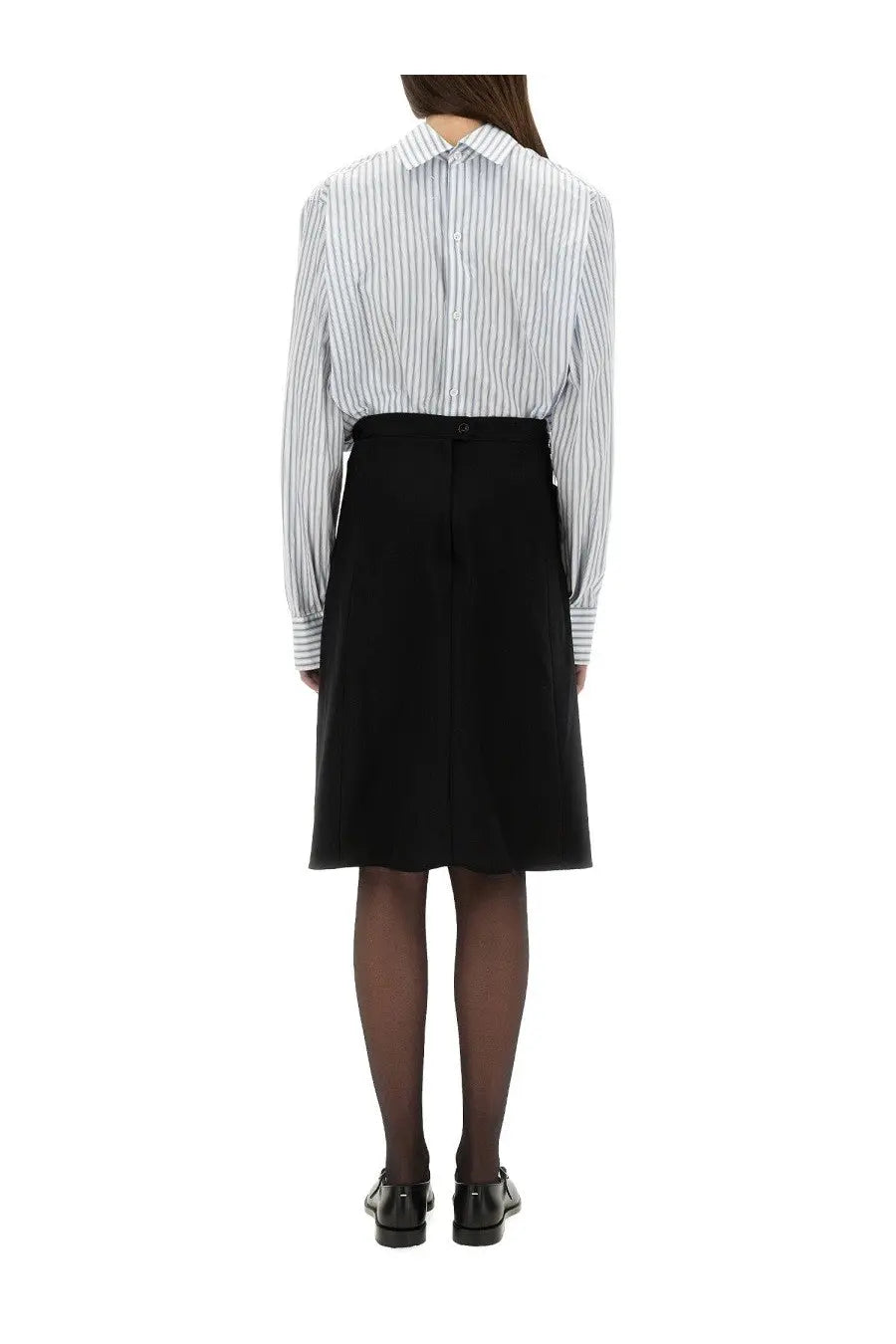 The back side of a tailored black knee-length skirt with a central seam matching maison margiela style