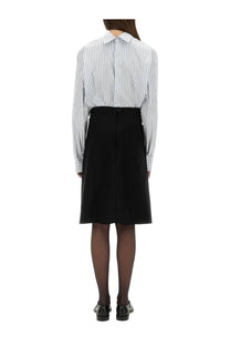 The back side of a tailored black knee-length skirt with a central seam matching maison margiela style