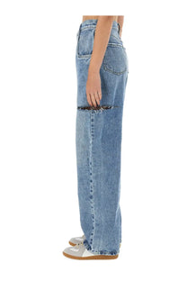 Maison Margiela women’s light-wash denim jeans with wide-leg cut and intentional distressing at the thigh in blue