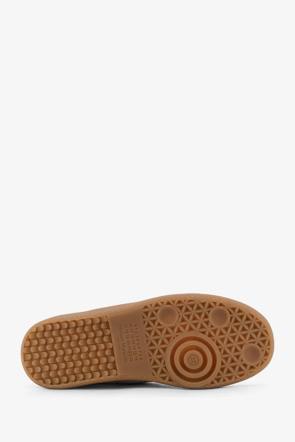 Tan rubber sole with textured pattern and circular tread on maison margiela women’s white leather sneakers