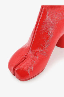 Maison Margiela women’s leather tabi boots in vibrant red patent leather with glossy finish and distinct toe separation