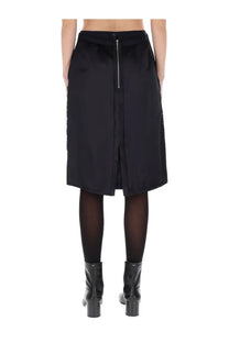 Maison Margiela women’s black satin midi skirt with central zipper closure and subtle pleats