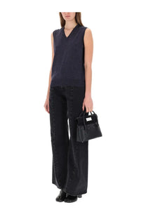 Black leather mini handbag with structured design and silver-tone hardware shown with maison margiela womens neck vest blue