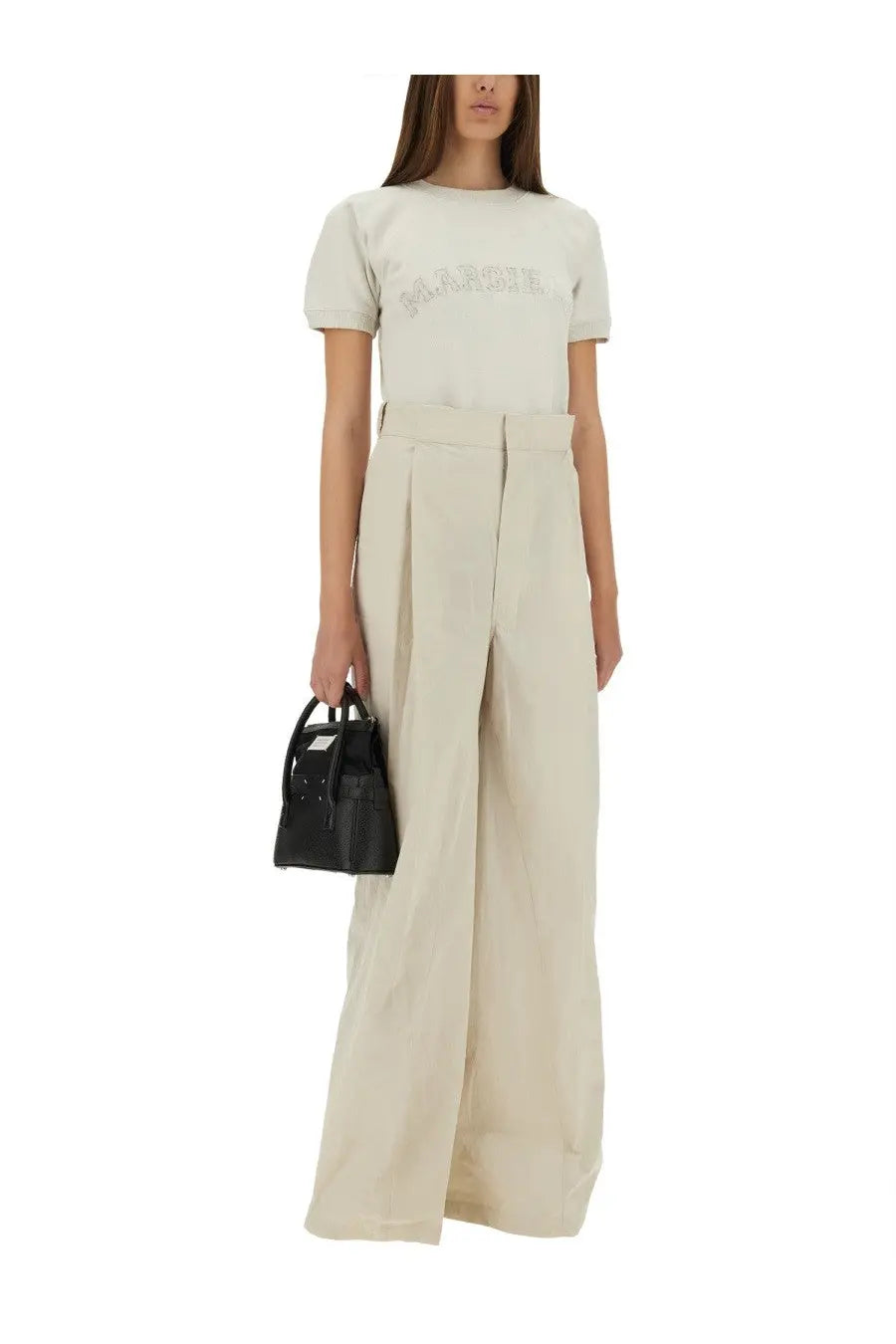 Maison margiela women’s pants white paired with a minimalist black leather mini handbag with top handles