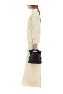 Black textured leather handbag with structured dome shape and silver-tone hardware for stylish use