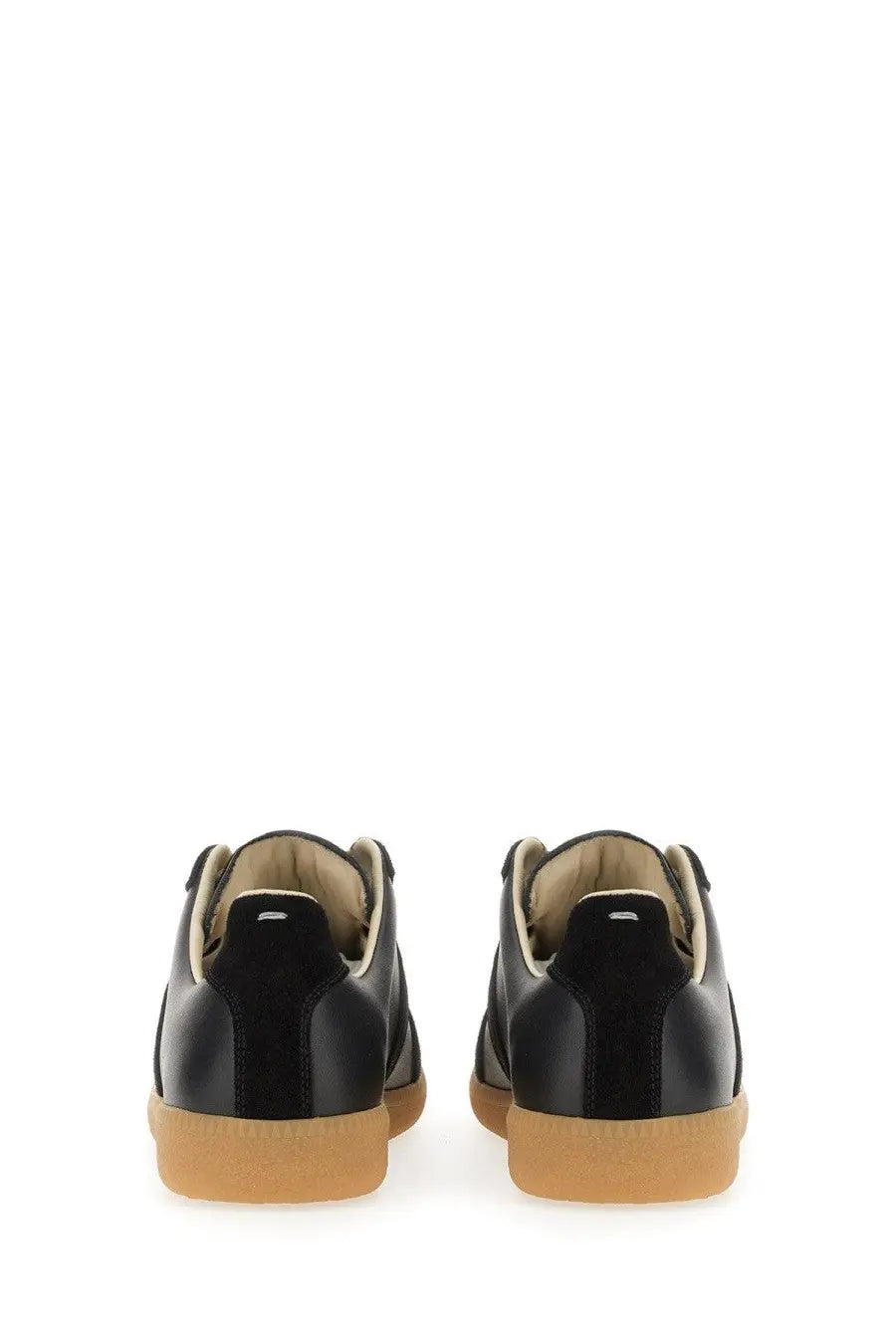 Maison Margiela women’s replica sneaker black leather with tan rubber sole and suede accents side view