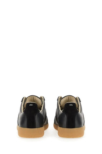 Maison Margiela women’s replica sneaker black leather with tan rubber sole and suede accents side view