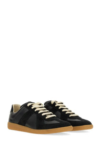 Maison Margiela women’s replica sneaker black with contrasting cream laces and tan rubber sole in leather material