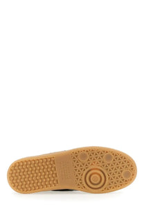 Tan rubber sole with geometric tread pattern and circular logo detail on maison margiela women’s replica sneaker black